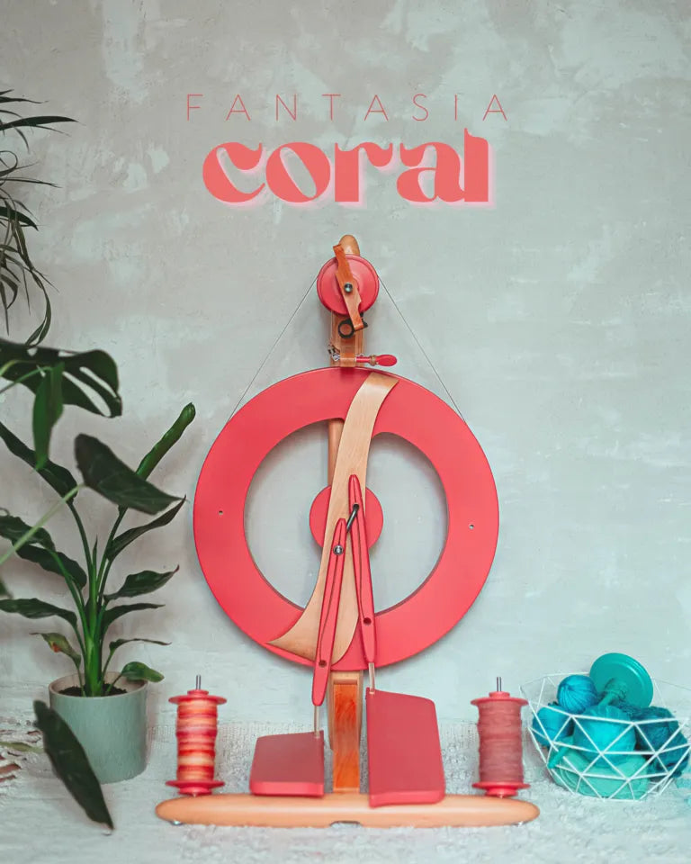 Dekorative Inszenierung des Fantasia Spinnrads in Coral neben Pflanzen und Garnkorb – modern & gemütlich.